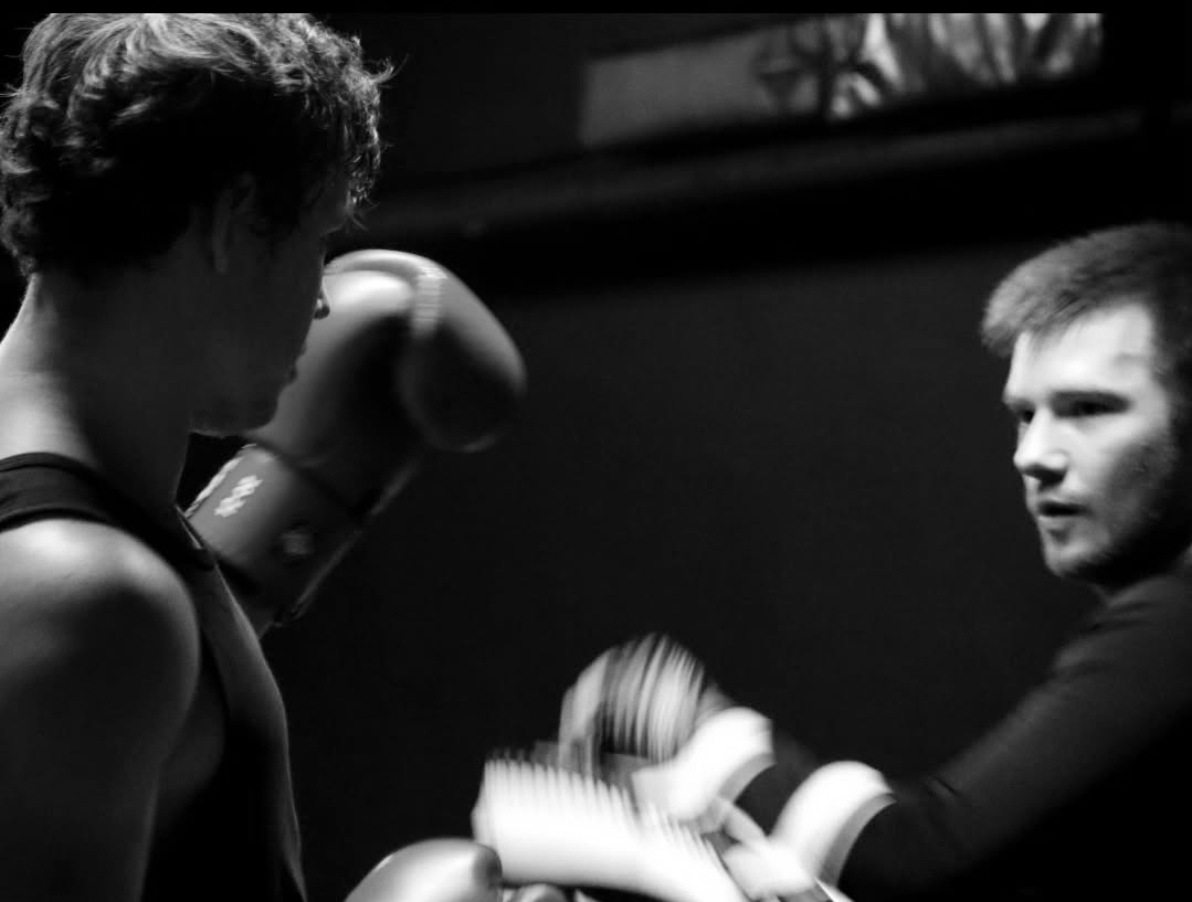 Coach working the pads with a student